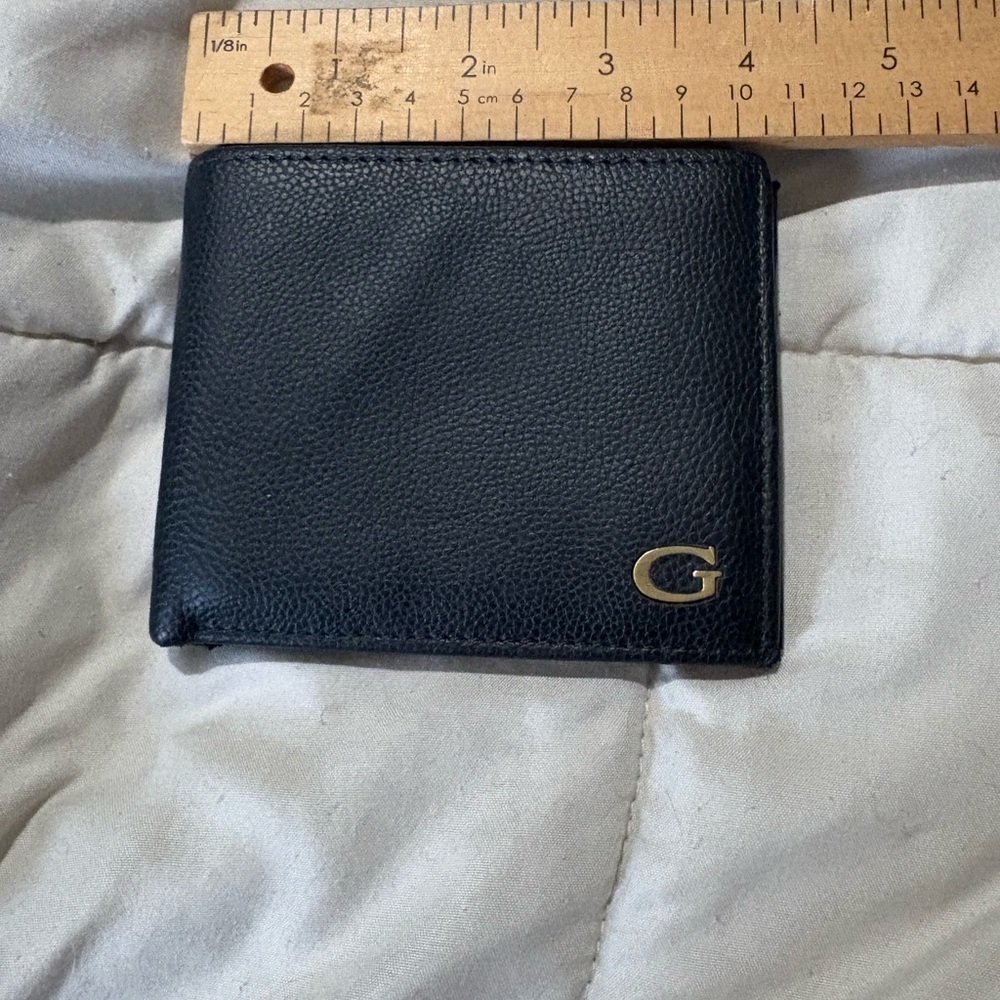 Guess men’s black bi-fold wallet gold hardware logo